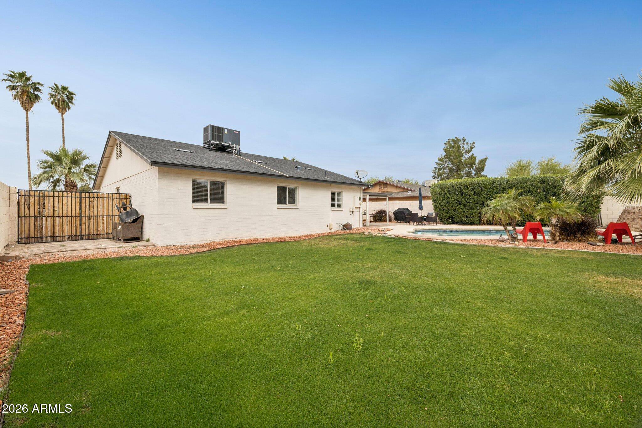 4723 South Country Club Way Tempe, AZ 85282 - Photo 33 of 46 a view of a white house with a big yard and potted plants