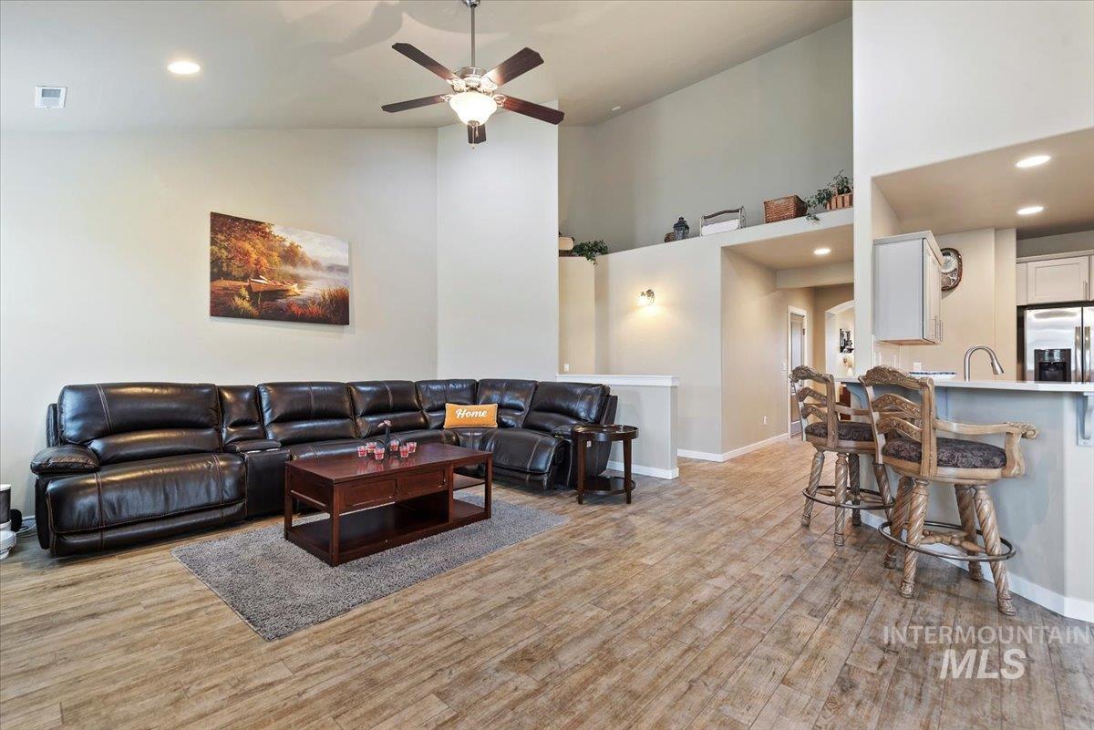 1011 West Riodosa Drive Meridian, ID 83642 - Photo 11 of 38 Living area featuring recessed lighting, a high ceiling, light wood-type flooring, and ceiling fan