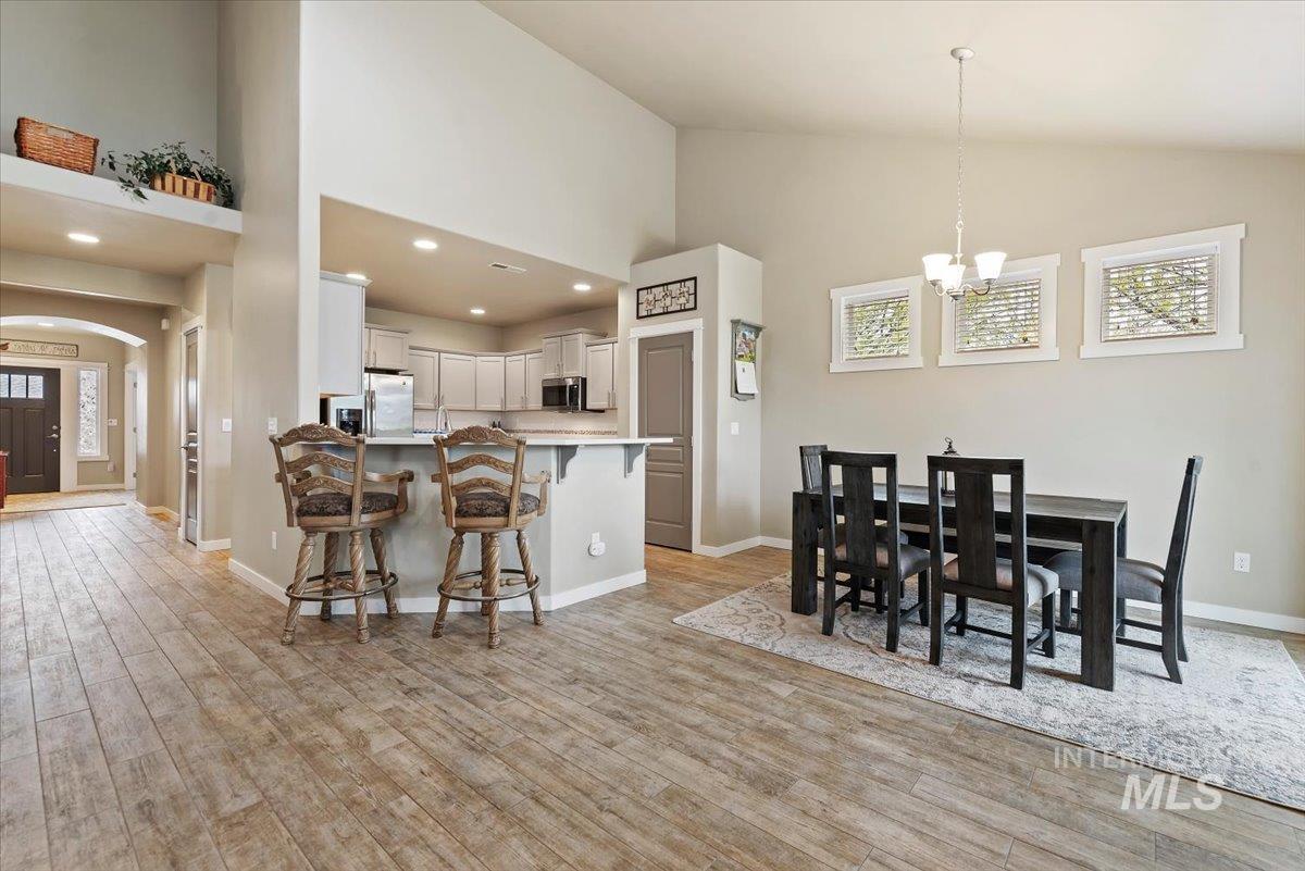 1011 West Riodosa Drive Meridian, ID 83642 - Photo 14 of 38 Kitchen with arched walkways, a breakfast bar area, light countertops, stainless steel appliances, and light wood-type flooring