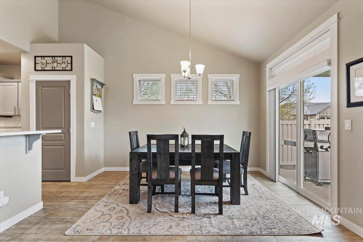 1011 West Riodosa Drive Meridian, ID 83642 - Photo 15 of 38 Dining space featuring lofted ceiling, light wood finished floors, and suspended lighting