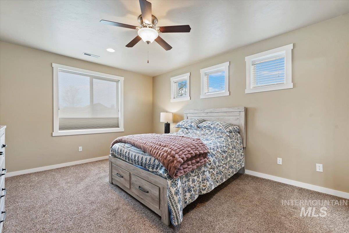 1011 West Riodosa Drive Meridian, ID 83642 - Photo 19 of 38 Carpeted bedroom with baseboards and ceiling fan