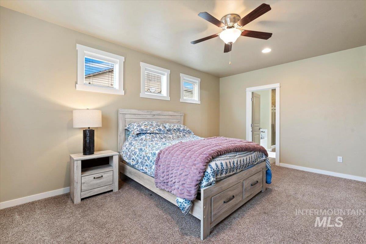 1011 West Riodosa Drive Meridian, ID 83642 - Photo 20 of 38 Carpeted bedroom with a ceiling fan, ensuite bath, and recessed lighting