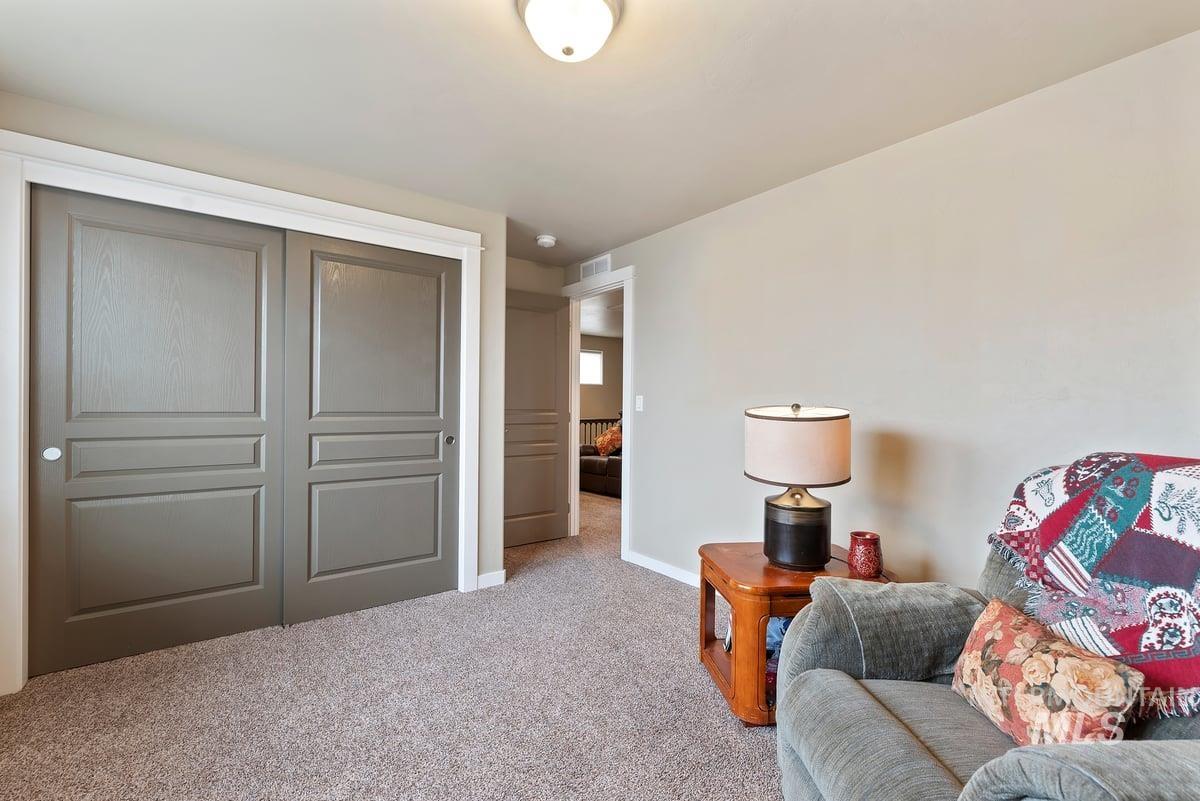 1011 West Riodosa Drive Meridian, ID 83642 - Photo 21 of 38 Living area featuring light colored carpet and baseboards