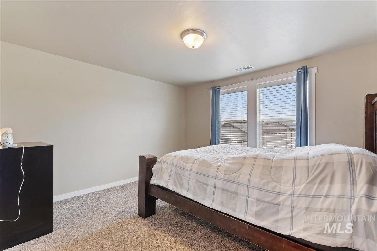 1011 West Riodosa Drive Meridian, ID 83642 - Photo 28 of 38 Bedroom with light colored carpet and baseboards