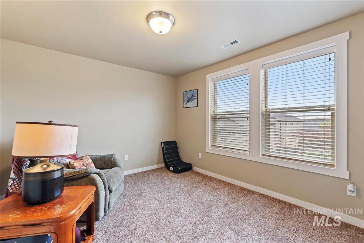 1011 West Riodosa Drive Meridian, ID 83642 - Photo 32 of 38 Living area with baseboards and light carpet