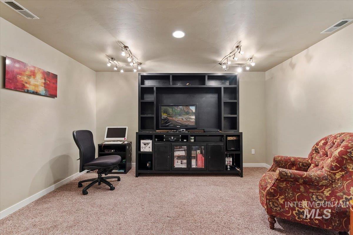 1011 West Riodosa Drive Meridian, ID 83642 - Photo 33 of 38 Office featuring light carpet, track lighting, and built in shelves