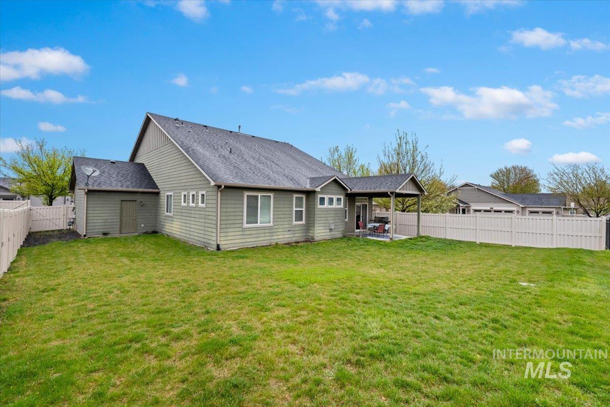 1011 West Riodosa Drive Meridian, ID 83642 - Photo 36 of 38 Back of house featuring a patio, a shingled roof, and a fenced backyard