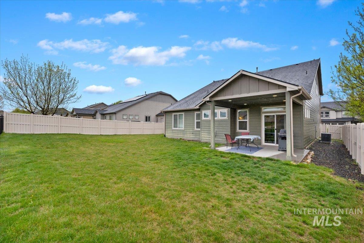 1011 West Riodosa Drive Meridian, ID 83642 - Photo 37 of 38 Rear view of property with board and batten siding, a patio, and a fenced backyard