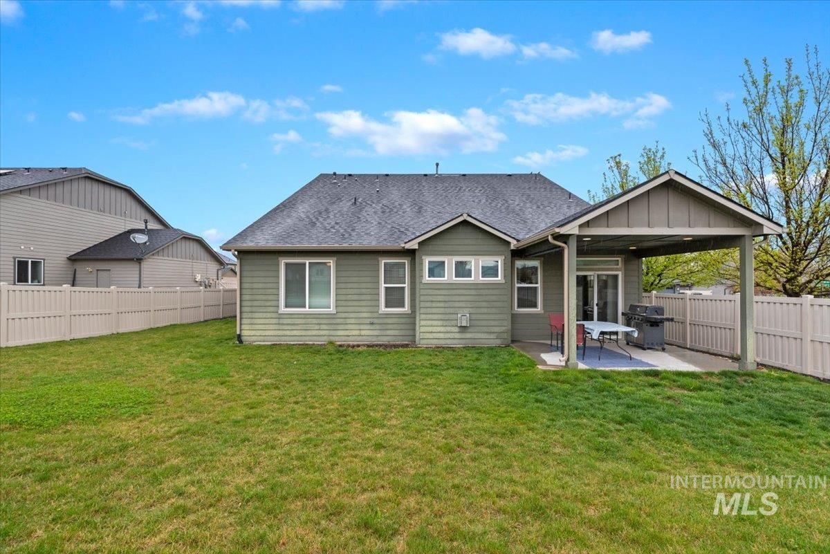 1011 West Riodosa Drive Meridian, ID 83642 - Photo 38 of 38 Back of house with a fenced backyard, a patio area, and roof with shingles