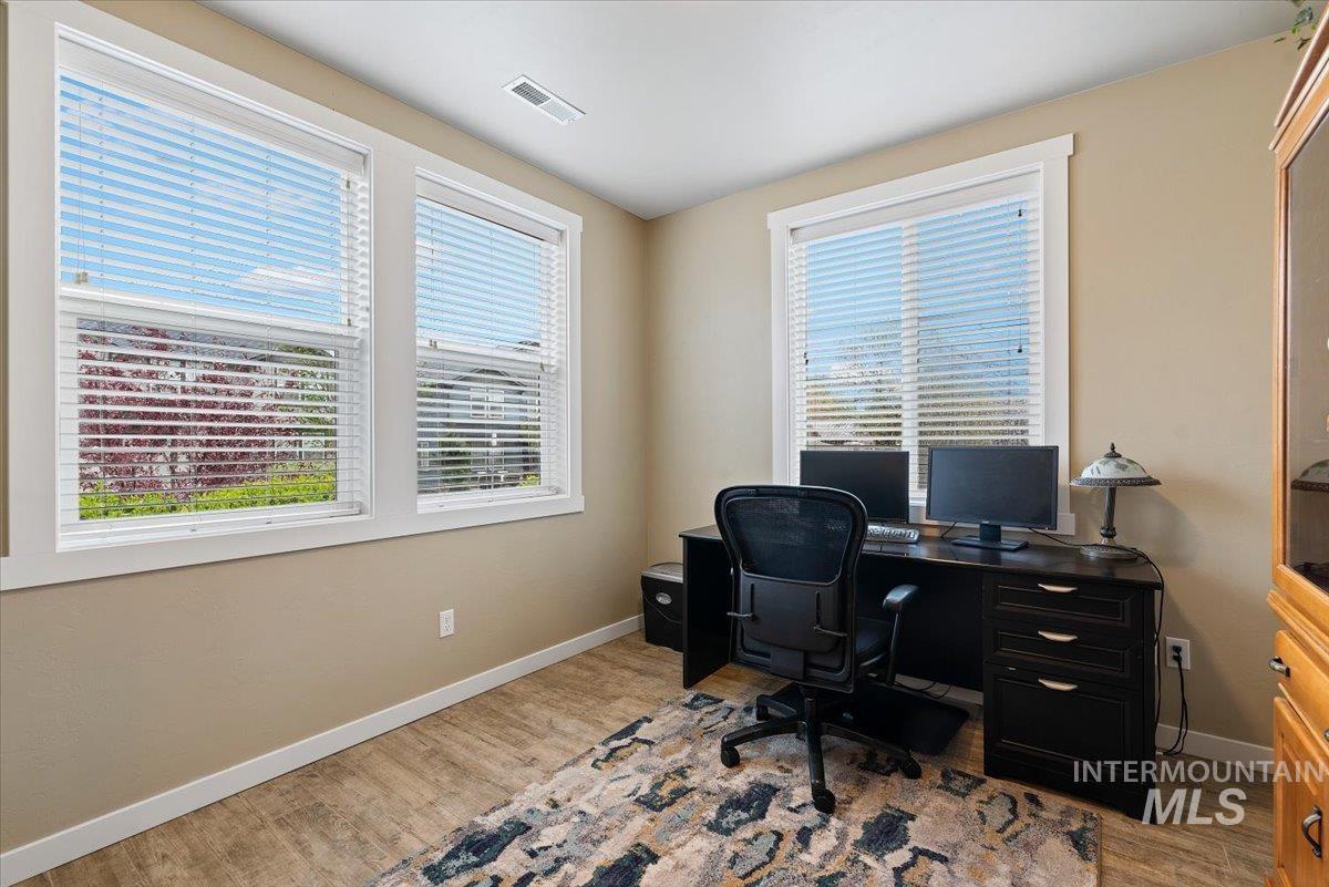 1011 West Riodosa Drive Meridian, ID 83642 - Photo 7 of 38 Home office featuring light wood-style floors and baseboards