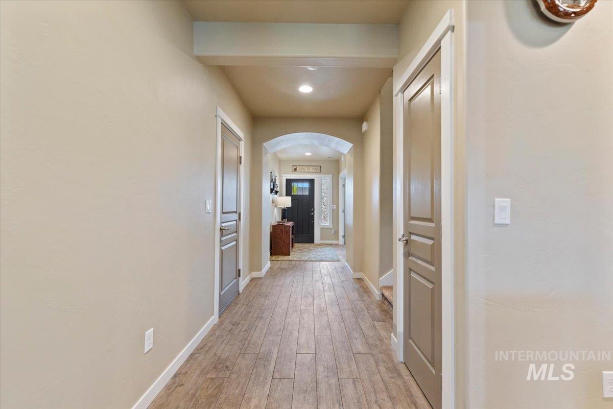1011 West Riodosa Drive Meridian, ID 83642 - Photo 9 of 38 Corridor with arched walkways, recessed lighting, and light wood-style flooring