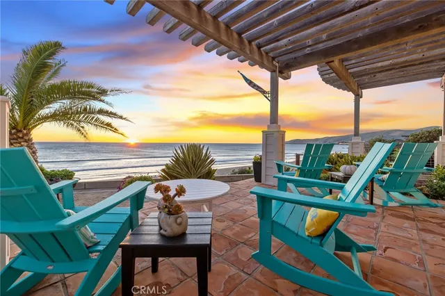a view of a chairs and table in the balcony