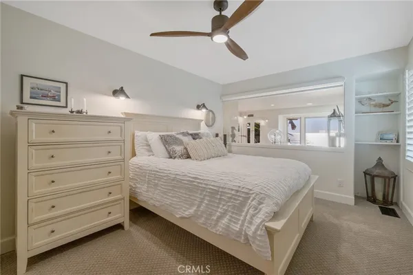 a spacious bedroom with a bed and glass door