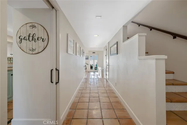 a living room with couches a dining table and chairs with wooden floor