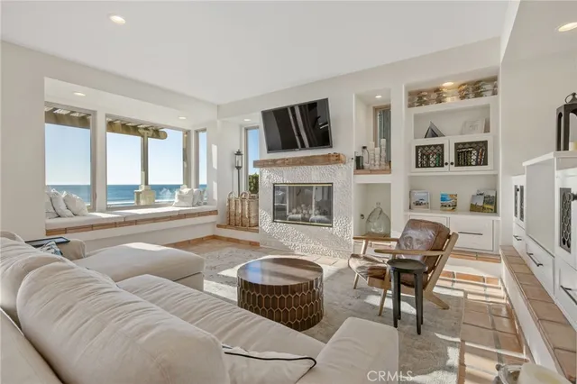 a large white kitchen with cabinets and a couch