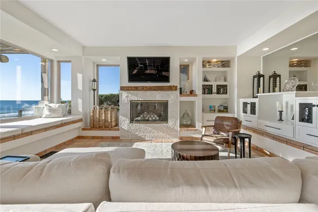 a living room with furniture a rug and kitchen view