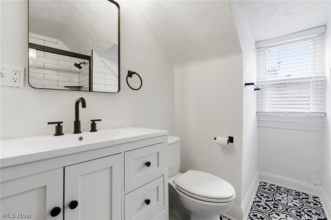 3326 East Overlook Road Cleveland Heights, OH 44118 - Photo 29 of 29 Bathroom featuring a white vanity with matte black hardware, coordinating black faucet, and a rectangular mirror