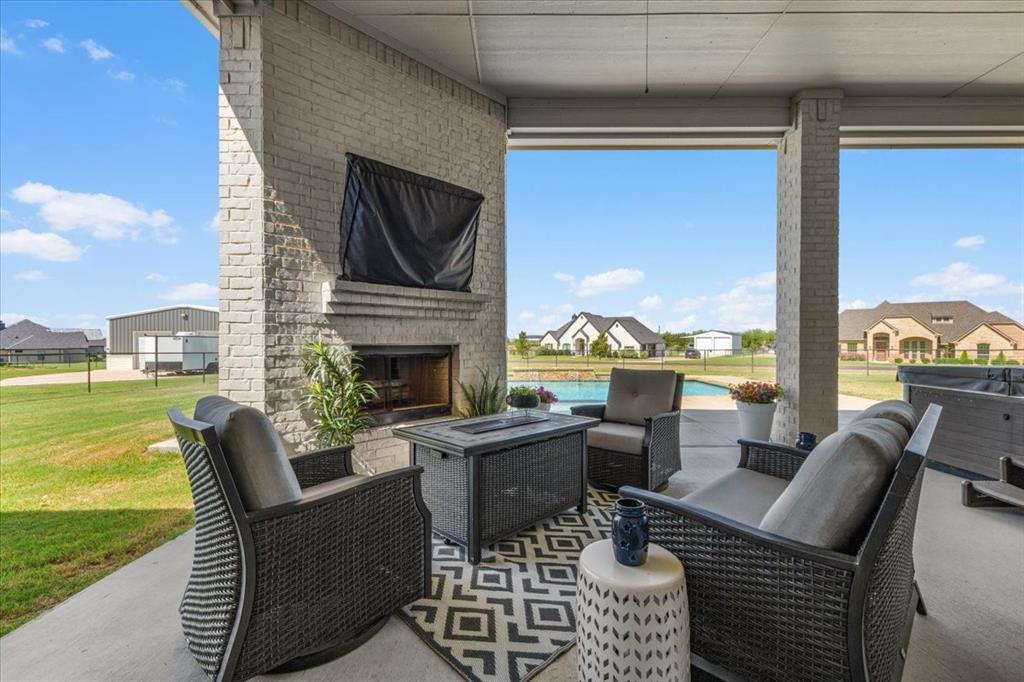 329 Palo Alto Drive Springtown, TX 76082 - Photo 27 of 34 Covered patio featuring a brick fireplace and view of the pool