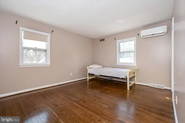 a room with a wooden floor and a window