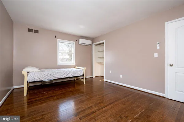 a living room with hard wood floors and a window
