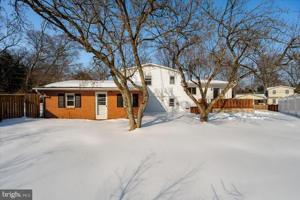 a view of a house with a snow in the yard