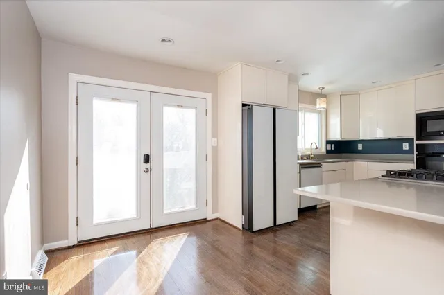 a kitchen with stainless steel appliances a refrigerator and a stove top oven