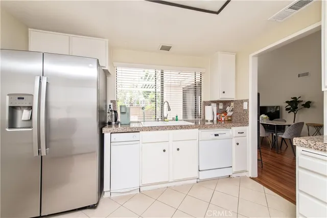 a kitchen with cabinets and stainless steel appliances