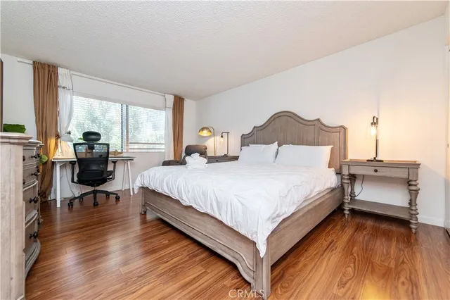 a spacious bedroom with a bed and window