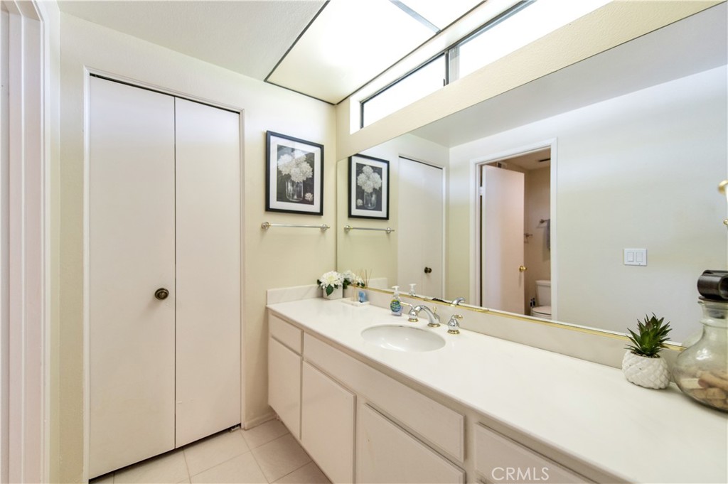 9 Morena, Unit 28 Irvine, CA 92612 - Photo 18 of 27 a bathroom with a double vanity sink and a mirror