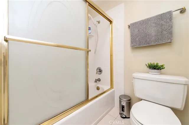 a white toilet sitting next to a bathroom sink and a mirror