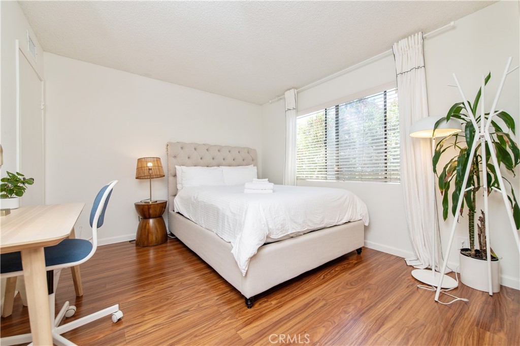 9 Morena, Unit 28 Irvine, CA 92612 - Photo 23 of 27 a bedroom with a bed and a table