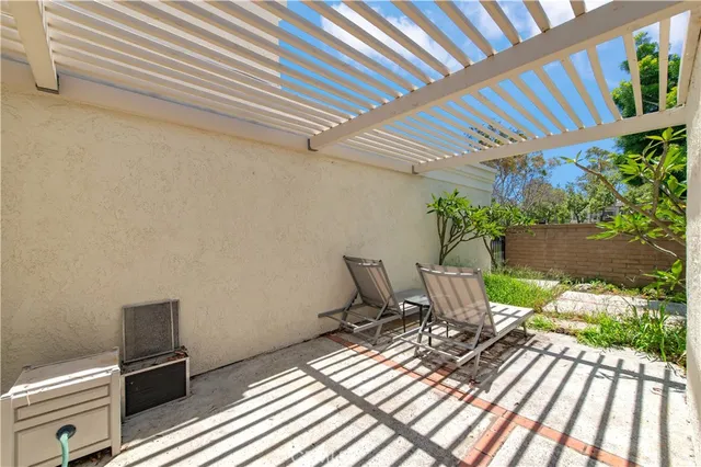 a view of a patio with table and chairs and potted plants