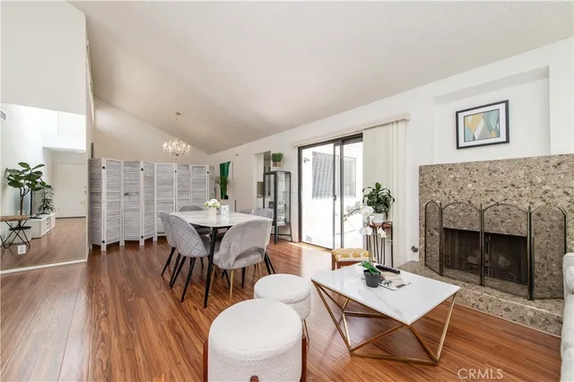 a dining room with furniture window and wooden floor