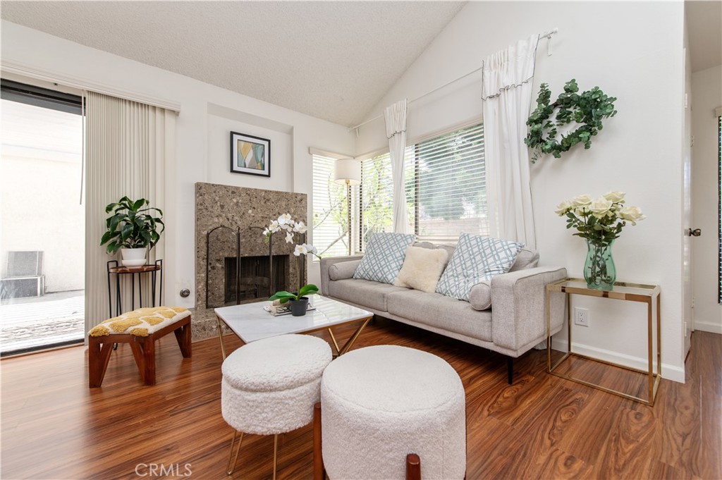 9 Morena, Unit 28 Irvine, CA 92612 - Photo 6 of 27 a living room with furniture a potted plant and a fireplace