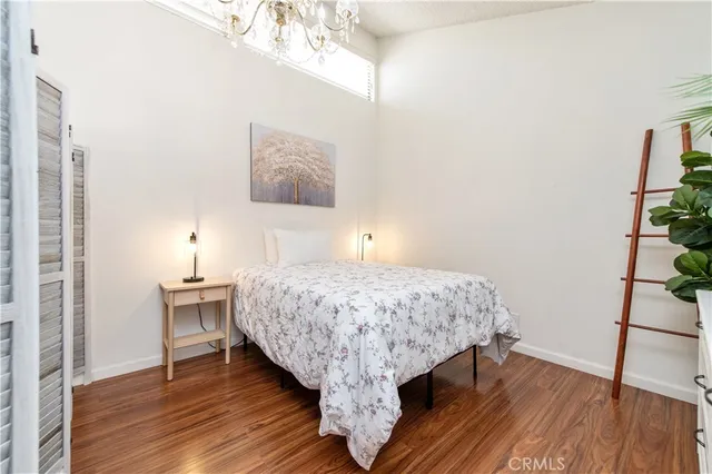 a bed sitting in a bedroom next to a window