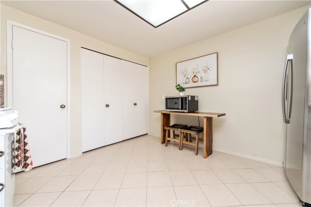 9 Morena, Unit 28 Irvine, CA 92612 - Photo 10 of 27 a view of a workspace with furniture and a refrigerator