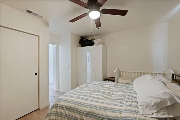 a bedroom with a bed and a chandelier