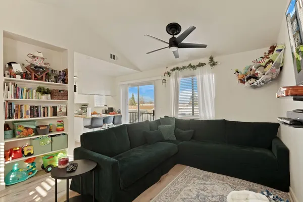 a living room with furniture and a book shelf