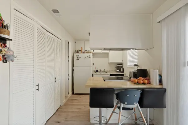 a kitchen with stainless steel appliances a refrigerator and a stove top oven