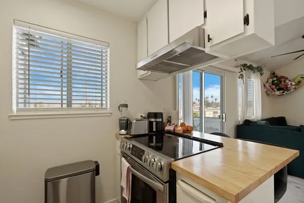 a kitchen with stainless steel appliances granite countertop a sink a stove and a refrigerator