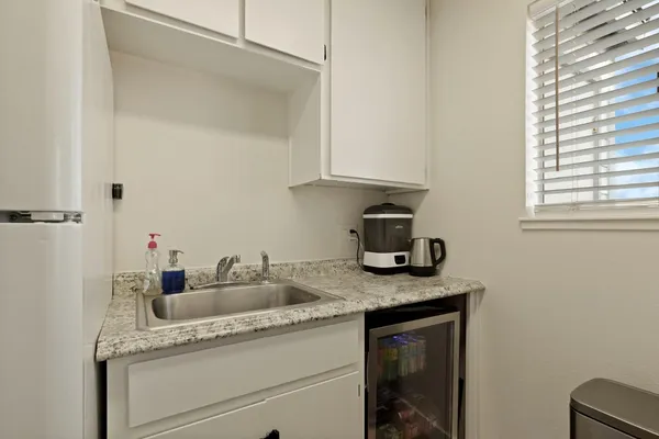 a kitchen with granite countertop a sink and cabinets
