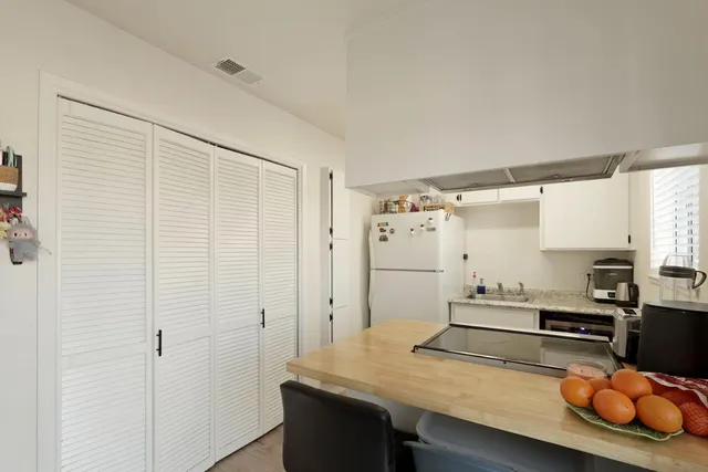 a kitchen with stainless steel appliances wooden floor and center island
