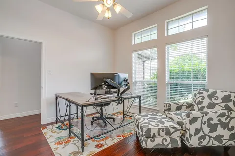 a view of a workspace with furniture and a window
