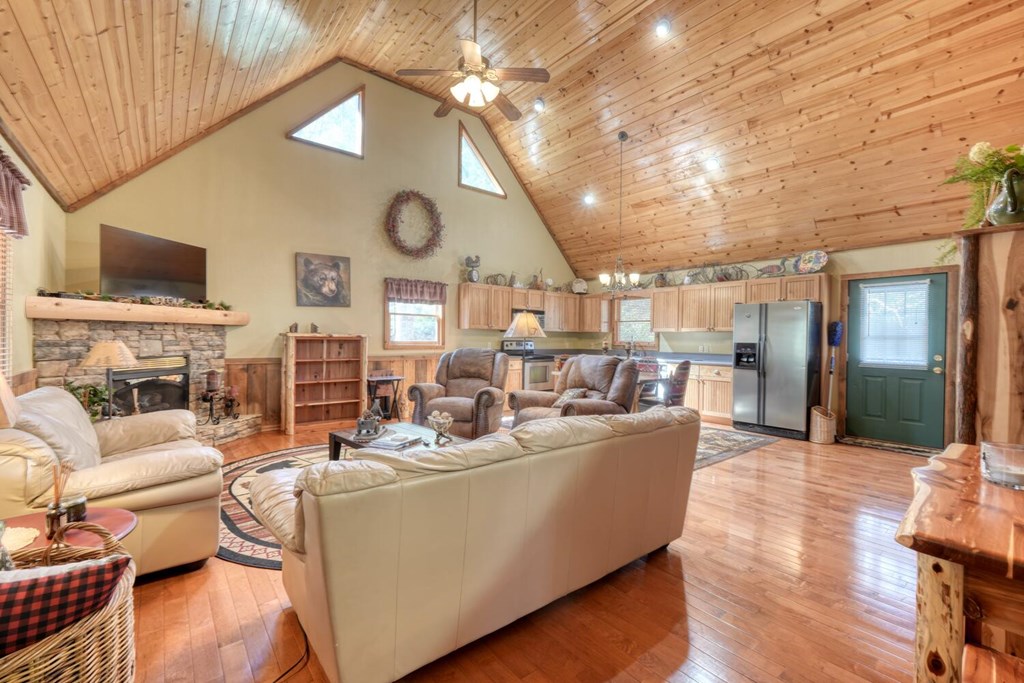 4852 Hf Lyons Road Hiawassee, GA 30546 - Photo 12 of 48 a living room with fireplace furniture and a chandelier