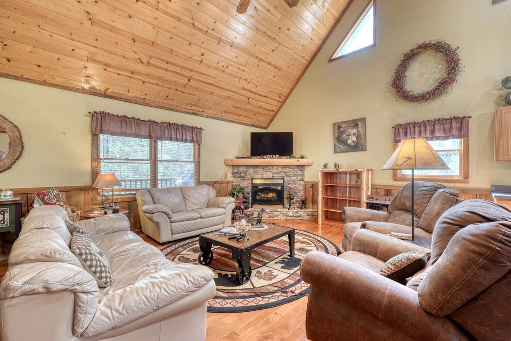 4852 Hf Lyons Road Hiawassee, GA 30546 - Photo 13 of 48 a living room with furniture a fireplace and a large window