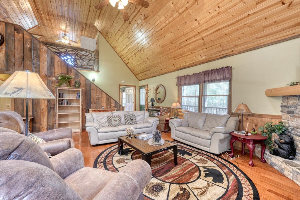 4852 Hf Lyons Road Hiawassee, GA 30546 - Photo 14 of 48 a living room with furniture and a floor to ceiling window