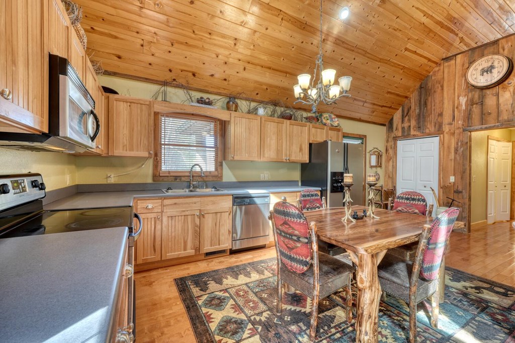 4852 Hf Lyons Road Hiawassee, GA 30546 - Photo 16 of 48 a kitchen with a dining table and chairs
