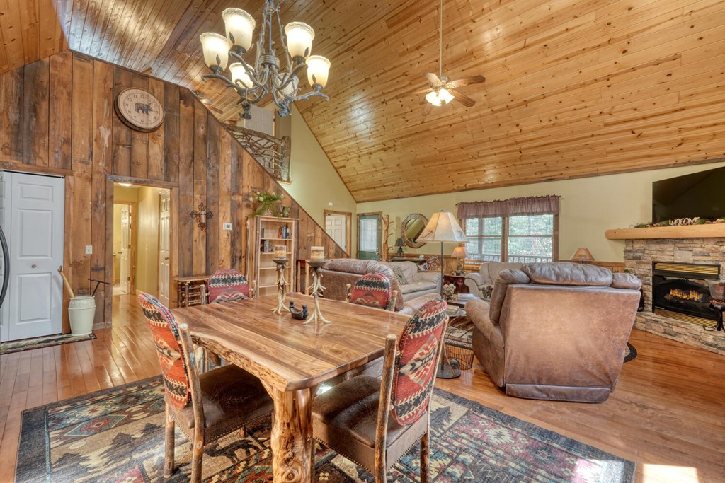4852 Hf Lyons Road Hiawassee, GA 30546 - Photo 17 of 48 a view of a dining room with furniture a rug and wooden floor
