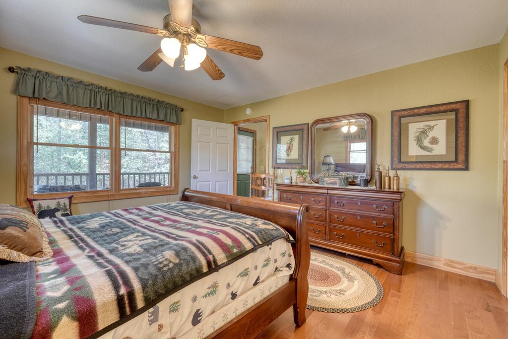 4852 Hf Lyons Road Hiawassee, GA 30546 - Photo 22 of 48 a bedroom with a bed and a large mirror on the dresser