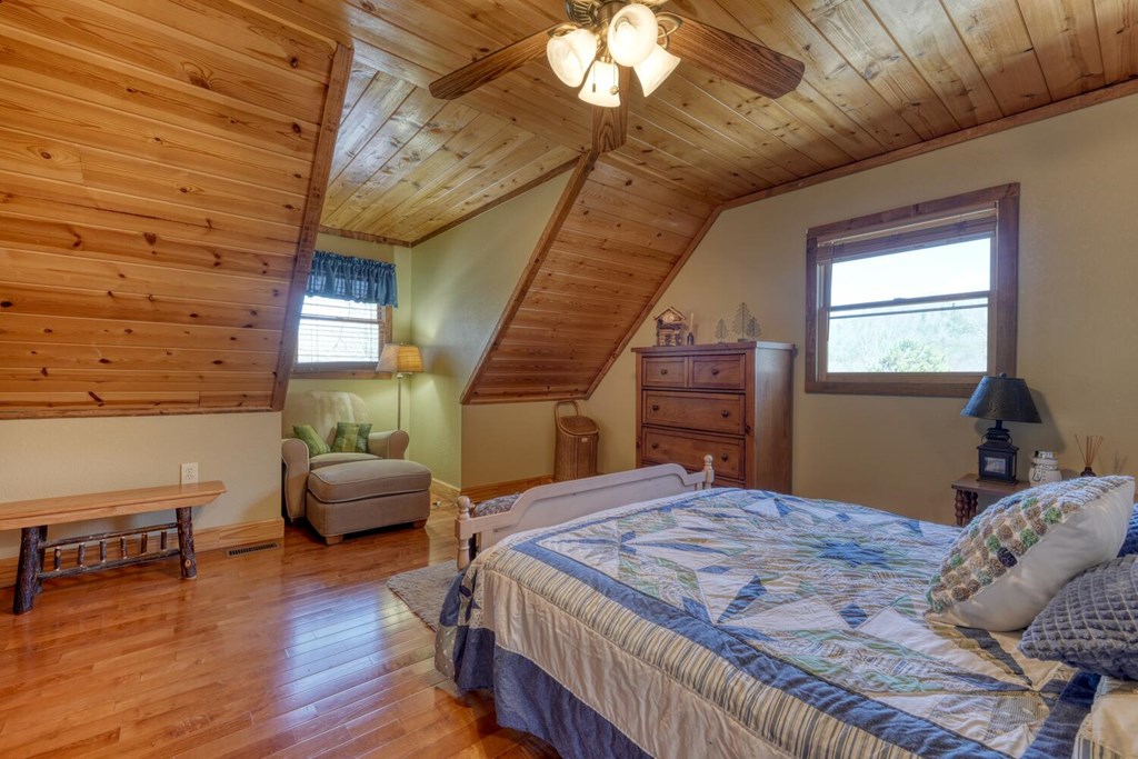 4852 Hf Lyons Road Hiawassee, GA 30546 - Photo 26 of 48 a bedroom with a bed and wooden floor